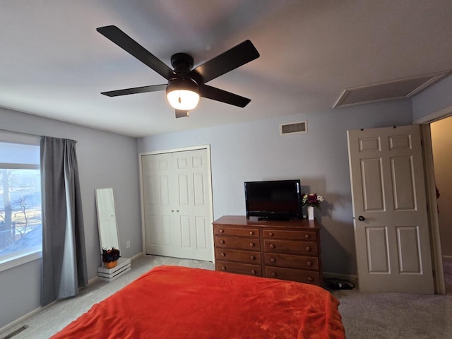 bedroom with baseboards, a closet, visible vents, and light colored carpet