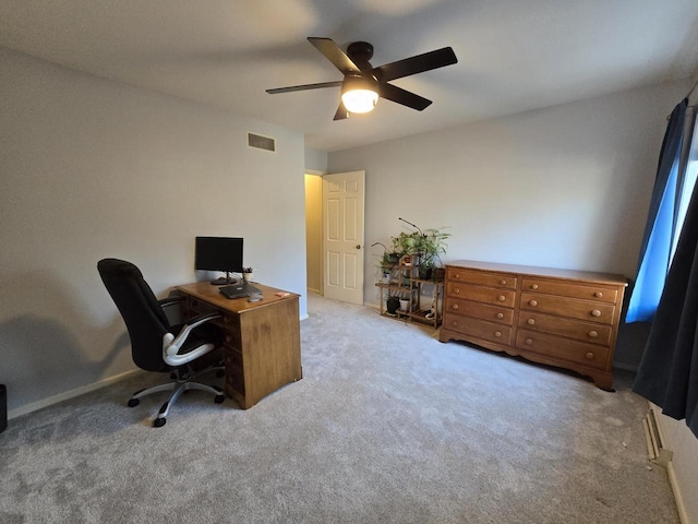 office space featuring carpet, visible vents, and a ceiling fan