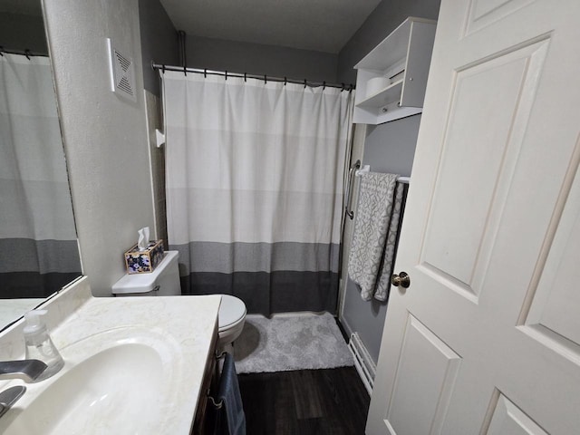 full bath with a shower with curtain, vanity, toilet, and wood finished floors