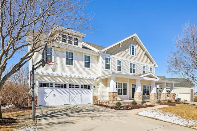 view of front facade featuring a garage, driveway, and a porch