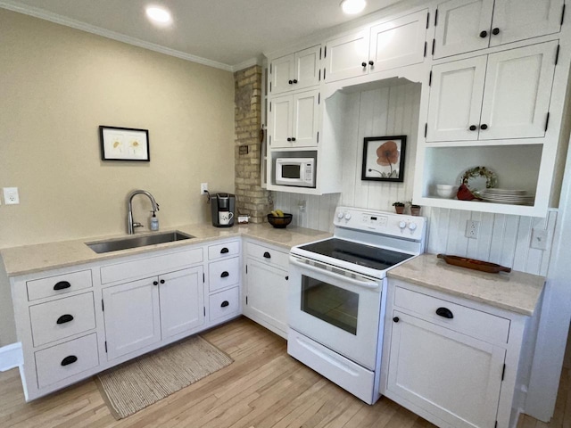 kitchen featuring white appliances, a sink, white cabinetry, light wood-type flooring, and crown molding