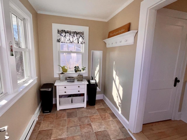 interior space featuring plenty of natural light, ornamental molding, and baseboards