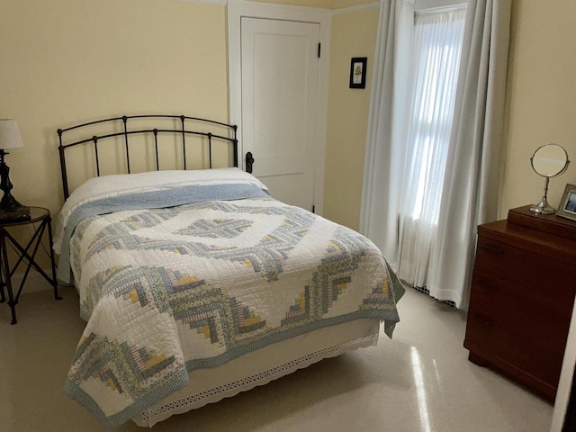 bedroom featuring concrete flooring