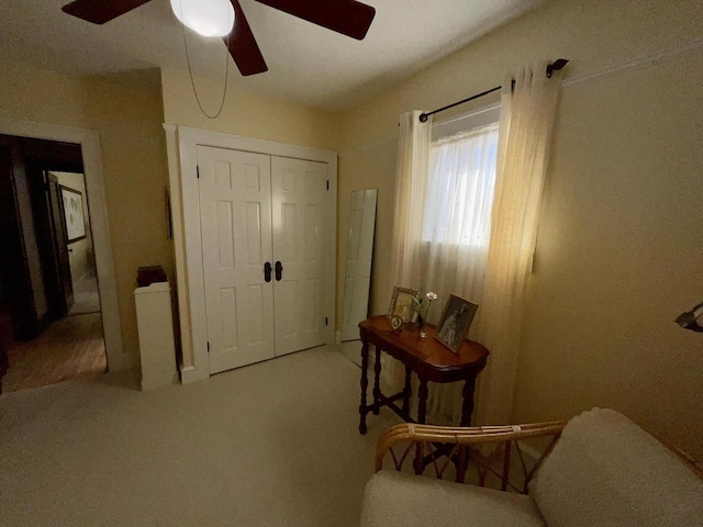 interior space with ceiling fan and carpet