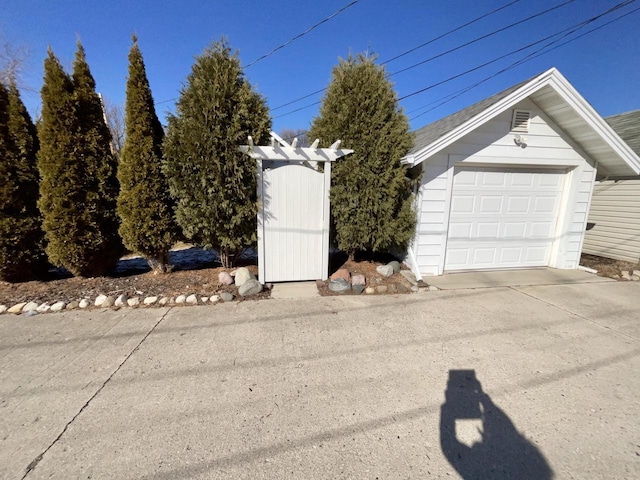 exterior space with driveway and an outbuilding