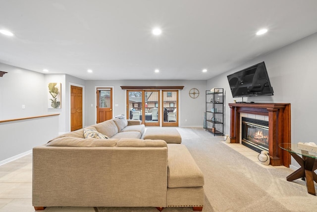 living area with recessed lighting, baseboards, light carpet, and a tiled fireplace