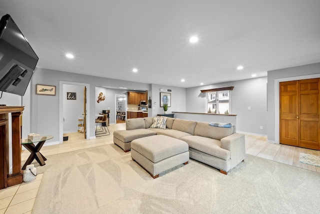 living area with light wood-style flooring, baseboards, and recessed lighting