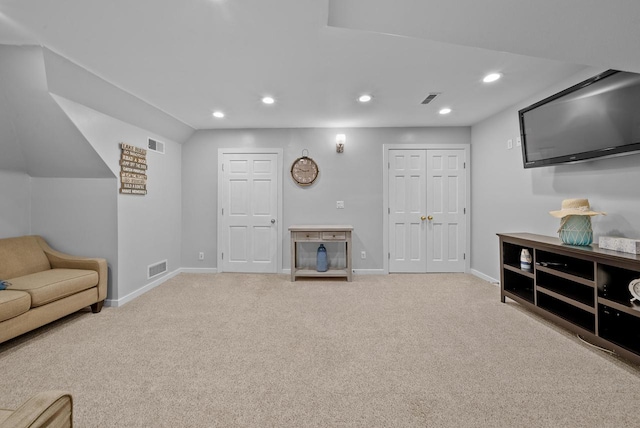 carpeted living area with baseboards, visible vents, and recessed lighting