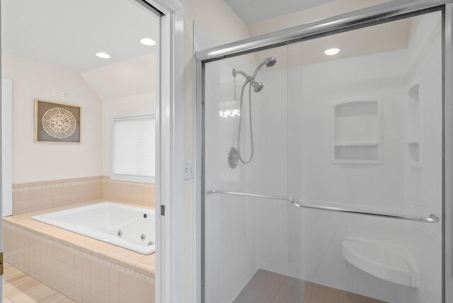 full bathroom with lofted ceiling, a stall shower, and a tub with jets