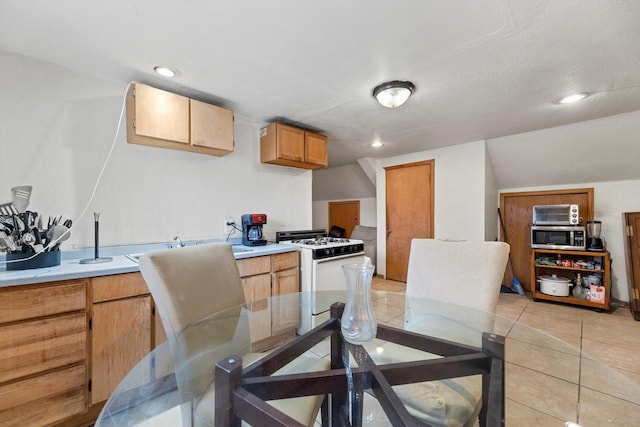 dining area featuring light tile patterned floors and recessed lighting