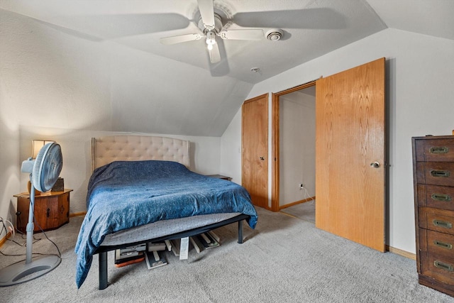 carpeted bedroom with lofted ceiling, baseboards, and a ceiling fan