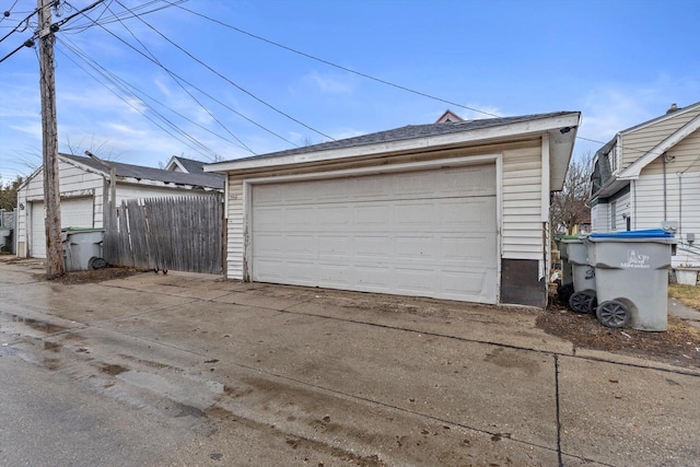 detached garage featuring fence