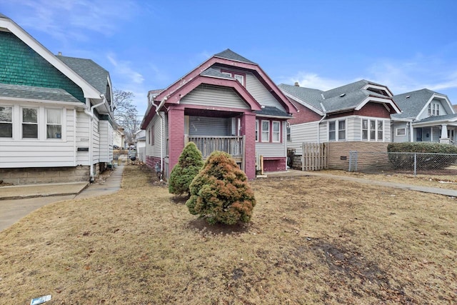 view of front of home with roof with shingles and fence