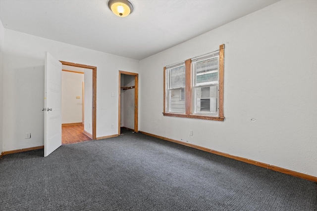 unfurnished bedroom with a closet, carpet flooring, and baseboards