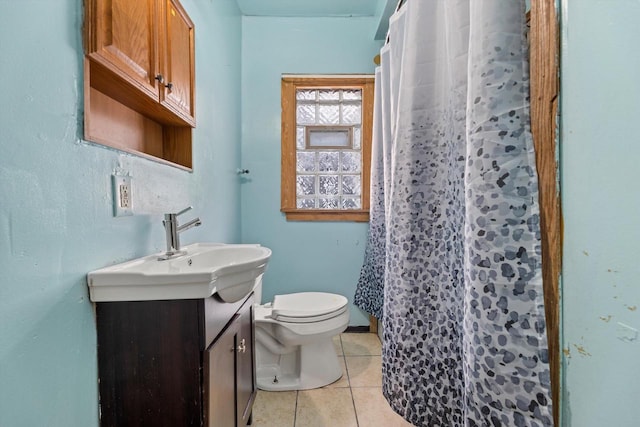 bathroom featuring tile patterned flooring, a shower with curtain, vanity, and toilet