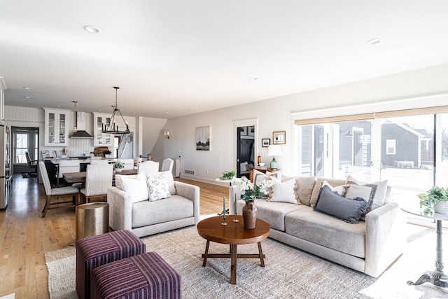 living area featuring recessed lighting, light wood-type flooring, and a healthy amount of sunlight