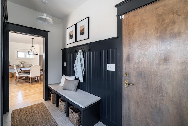 mudroom featuring a chandelier and light wood-type flooring