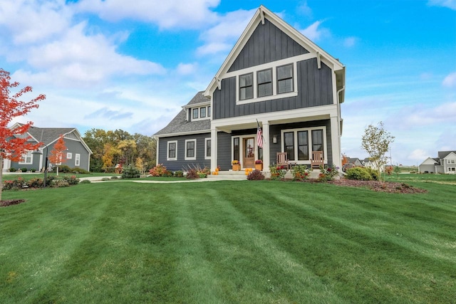 view of front of house with a porch, board and batten siding, a front lawn, and a shingled roof