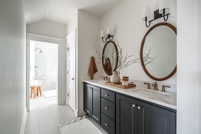 full bathroom featuring vaulted ceiling, double vanity, baseboards, and a sink