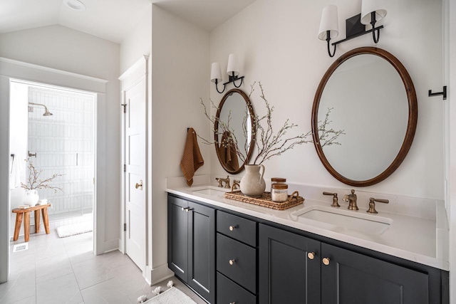 bathroom with lofted ceiling, double vanity, tile patterned floors, and a sink