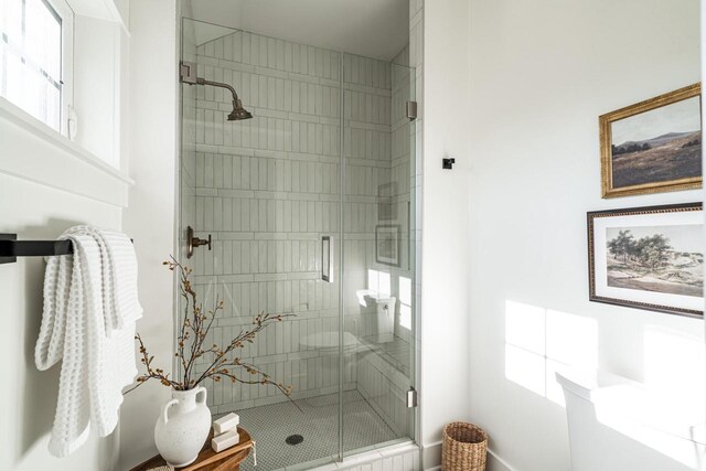 bathroom featuring plenty of natural light and a stall shower