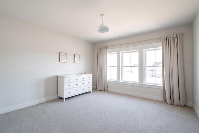 unfurnished bedroom with baseboards and light carpet