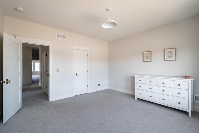 unfurnished bedroom with visible vents, carpet floors, and baseboards