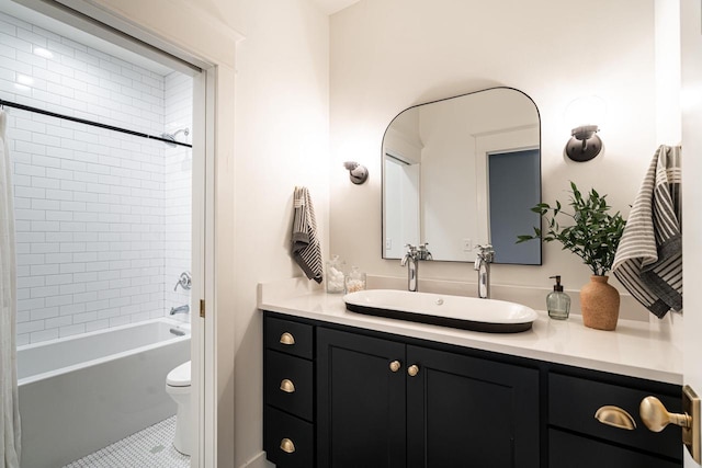 full bath featuring tile patterned floors, toilet, vanity, and shower / bathtub combination