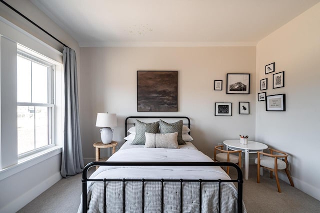 carpeted bedroom featuring baseboards