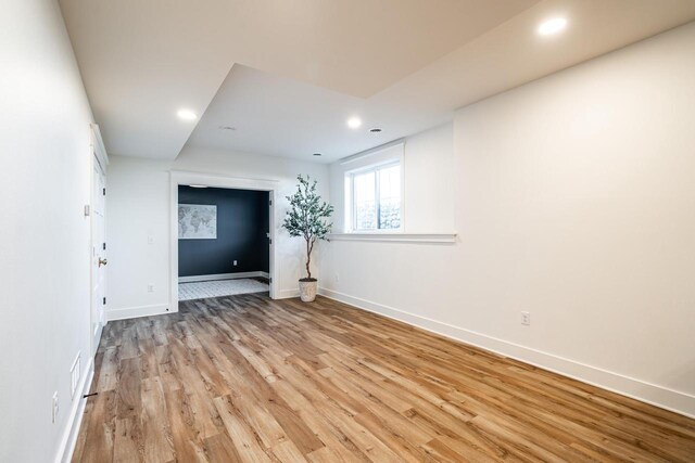 spare room featuring recessed lighting, baseboards, and light wood-style flooring