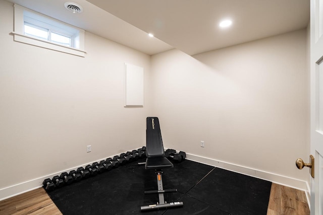 exercise area featuring visible vents, recessed lighting, baseboards, and wood finished floors