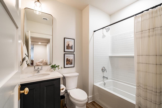 bathroom with visible vents, vanity, toilet, and shower / tub combo