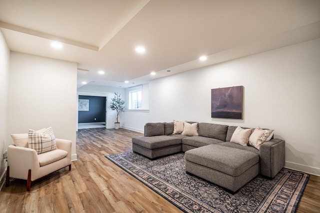 living area featuring recessed lighting, baseboards, and light wood-type flooring