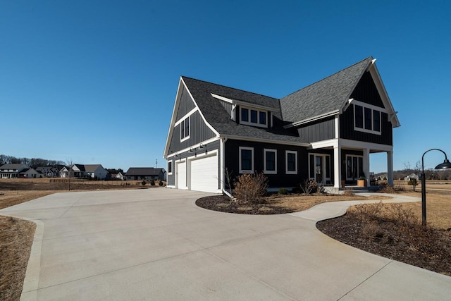 view of front of property featuring board and batten siding, concrete driveway, an attached garage, and a shingled roof