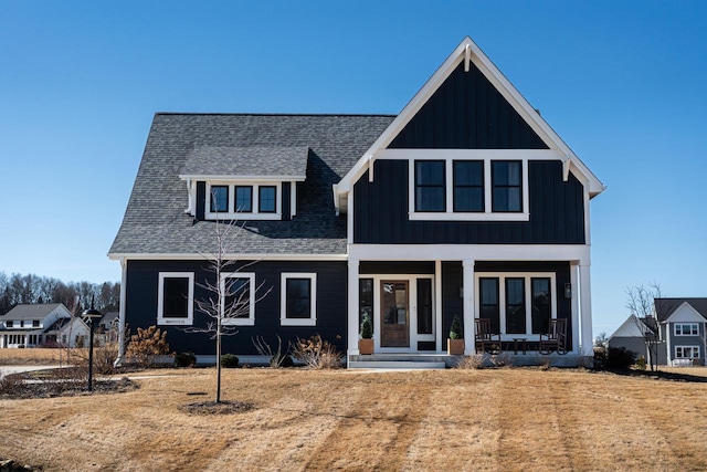 view of front of home featuring roof with shingles, board and batten siding, and covered porch