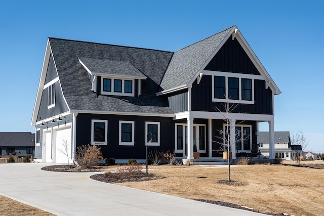 modern farmhouse featuring a porch, an attached garage, a shingled roof, concrete driveway, and board and batten siding