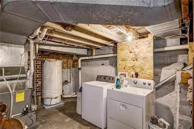 washroom featuring laundry area, independent washer and dryer, heating unit, and gas water heater