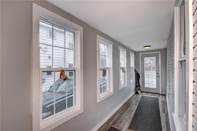 entryway with wood finished floors and baseboards