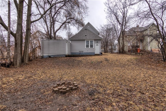 rear view of house with a fire pit