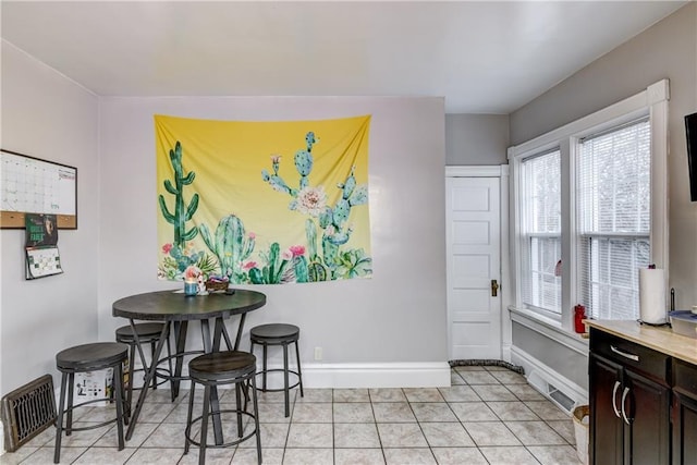 dining space featuring visible vents, baseboards, and light tile patterned floors