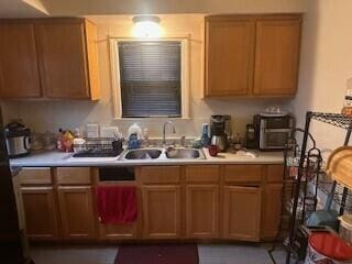 kitchen featuring light countertops and a sink