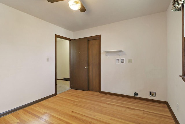 clothes washing area with laundry area, washer hookup, a ceiling fan, baseboards, and light wood-style floors