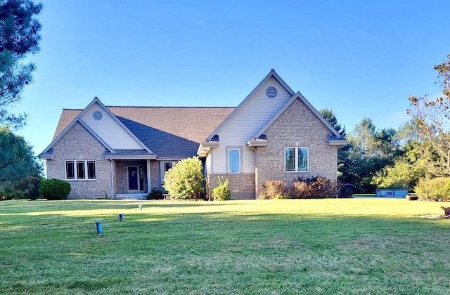 view of front of property featuring brick siding and a front lawn