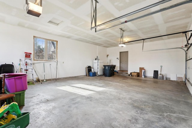 garage with freestanding refrigerator and a garage door opener