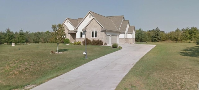 traditional-style home with a garage, concrete driveway, and a front yard