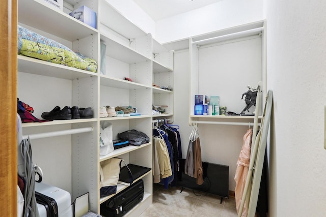 walk in closet featuring tile patterned flooring