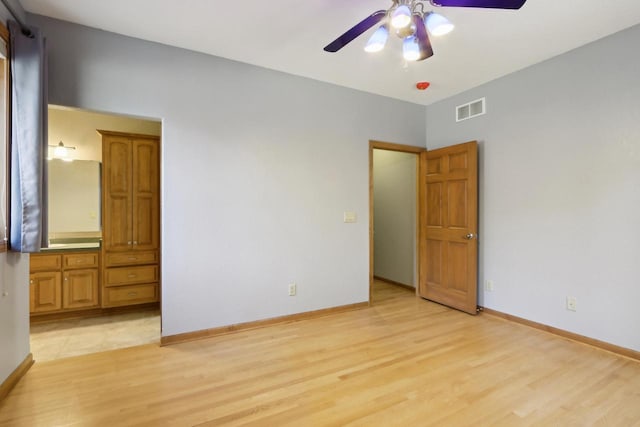 unfurnished bedroom with visible vents, baseboards, and light wood-style floors