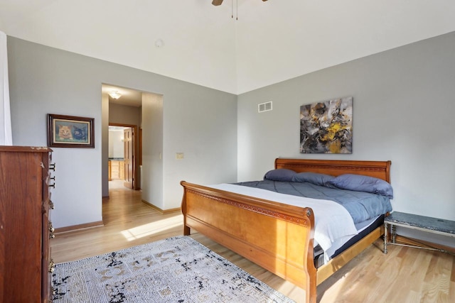 bedroom with ceiling fan, baseboards, visible vents, and light wood-type flooring