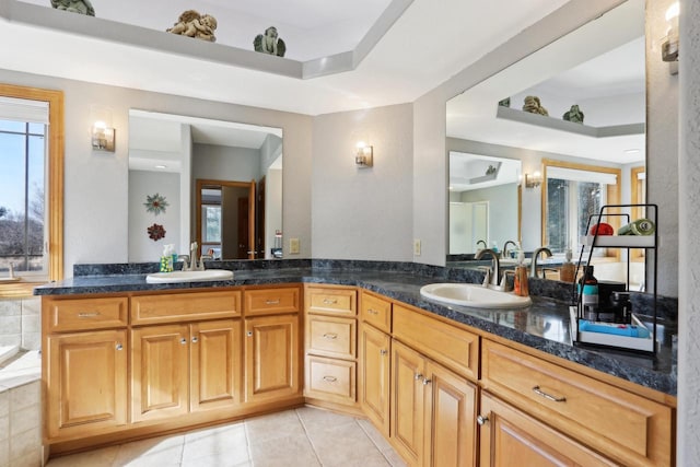 full bathroom featuring tile patterned flooring, a raised ceiling, double vanity, and a sink