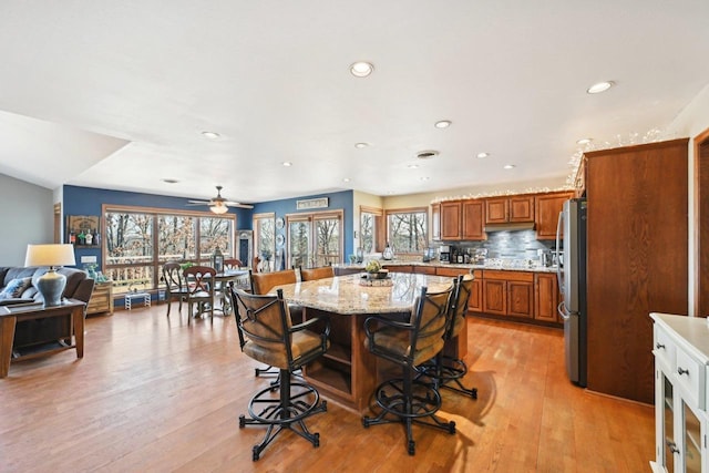 dining room featuring a ceiling fan, recessed lighting, and light wood-type flooring